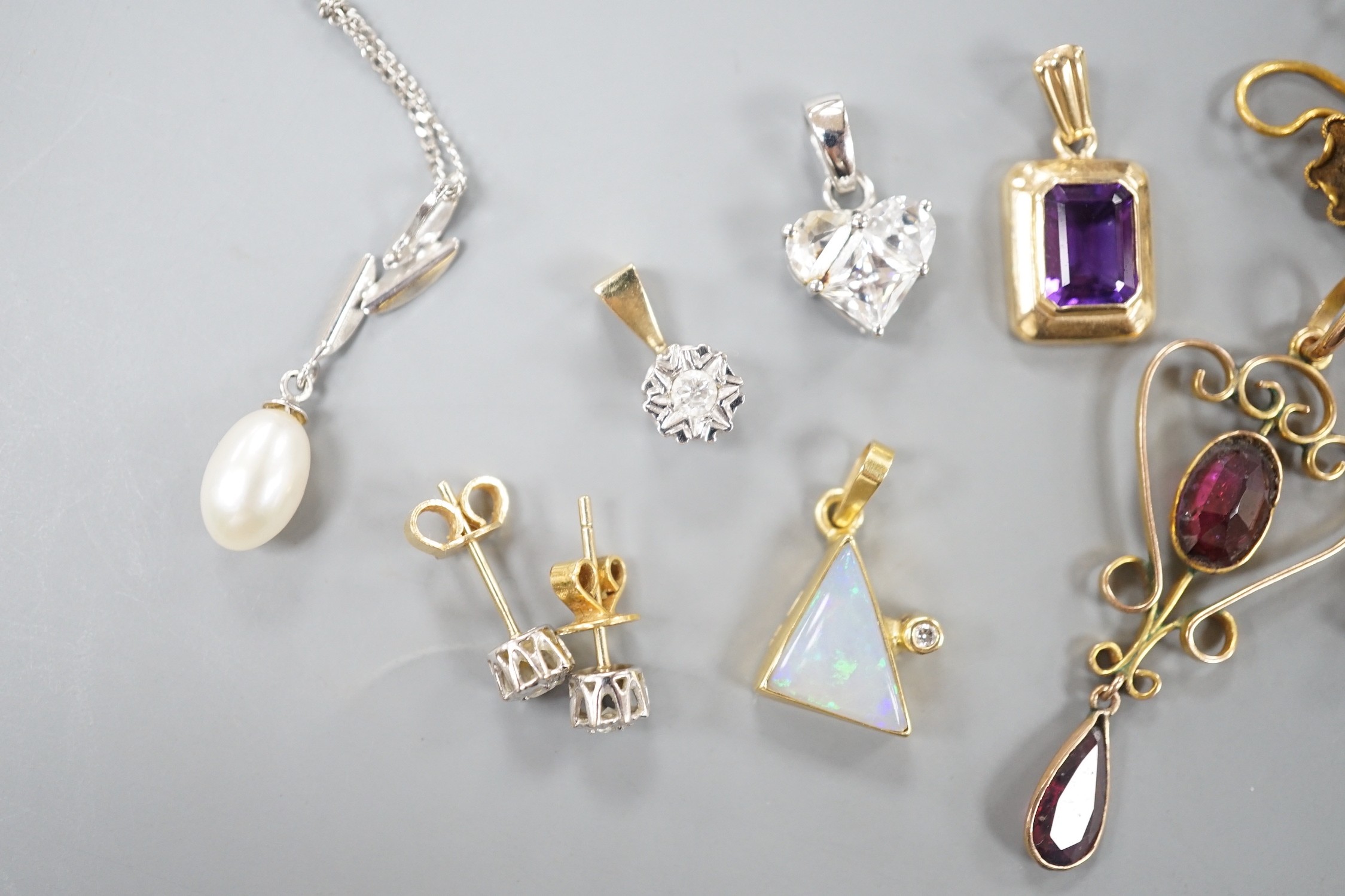Mixed jewellery including a pair of Victorian 15ct and diamond chip earrings, a modern amethyst pendant, a garnet set yellow metal pendant, two pairs of 750 and diamond set ear studs, a pair of 750 white metal, tanzanite
